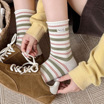 Ivory striped cotton crew socks styled with brown sneakers