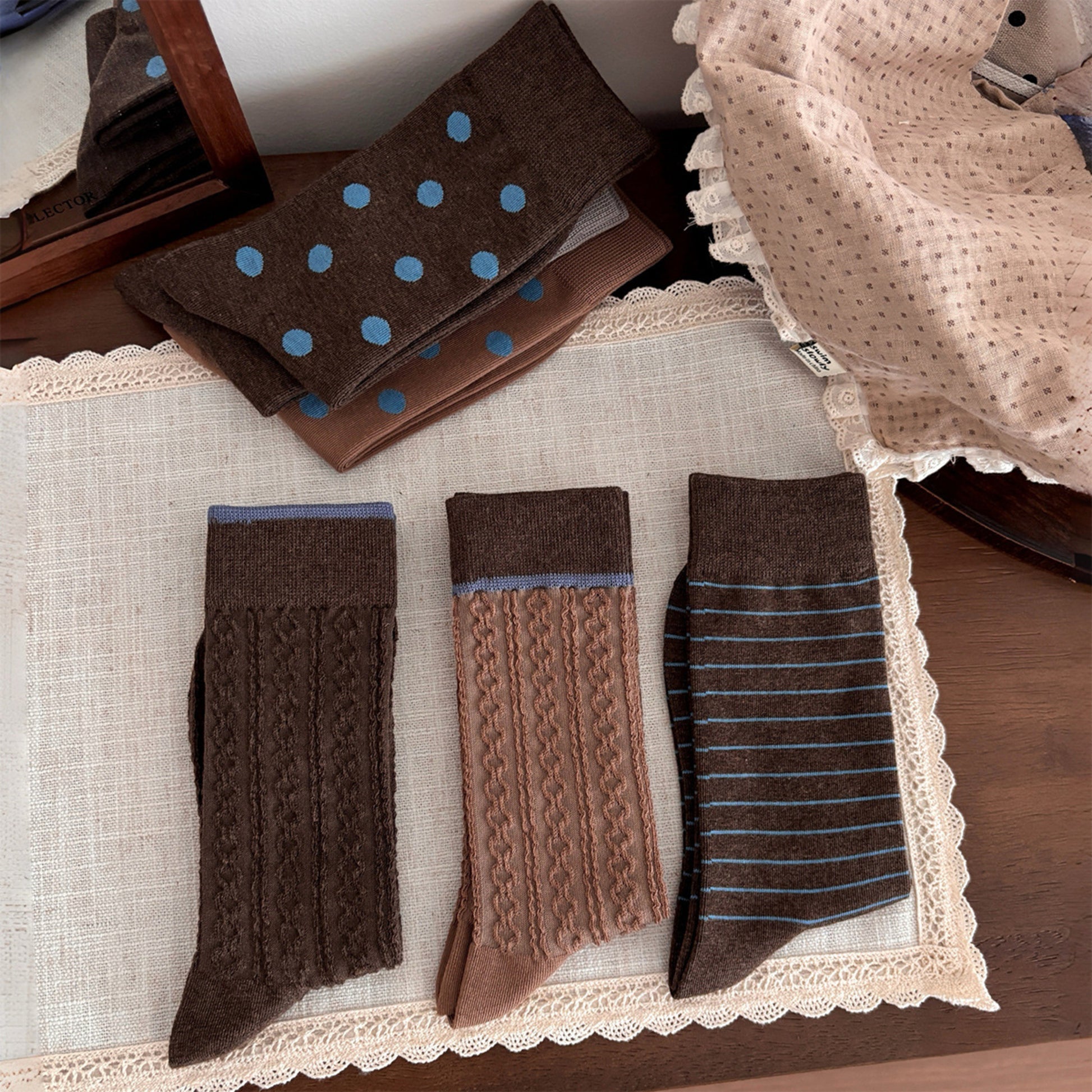 Six pairs of khaki and coffee brown textured socks arranged in a vintage flat lay