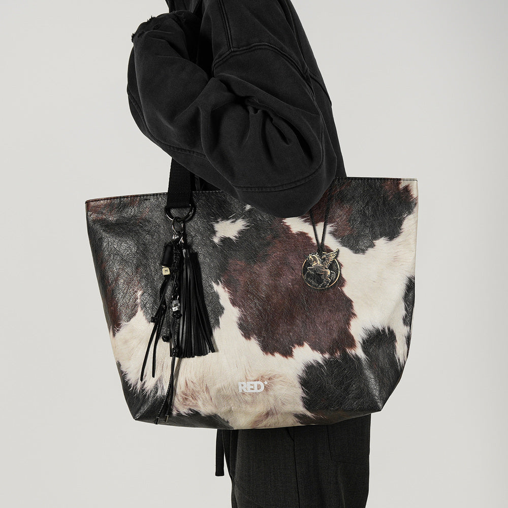 EMBER cow print Tyvek tote bag front styling view