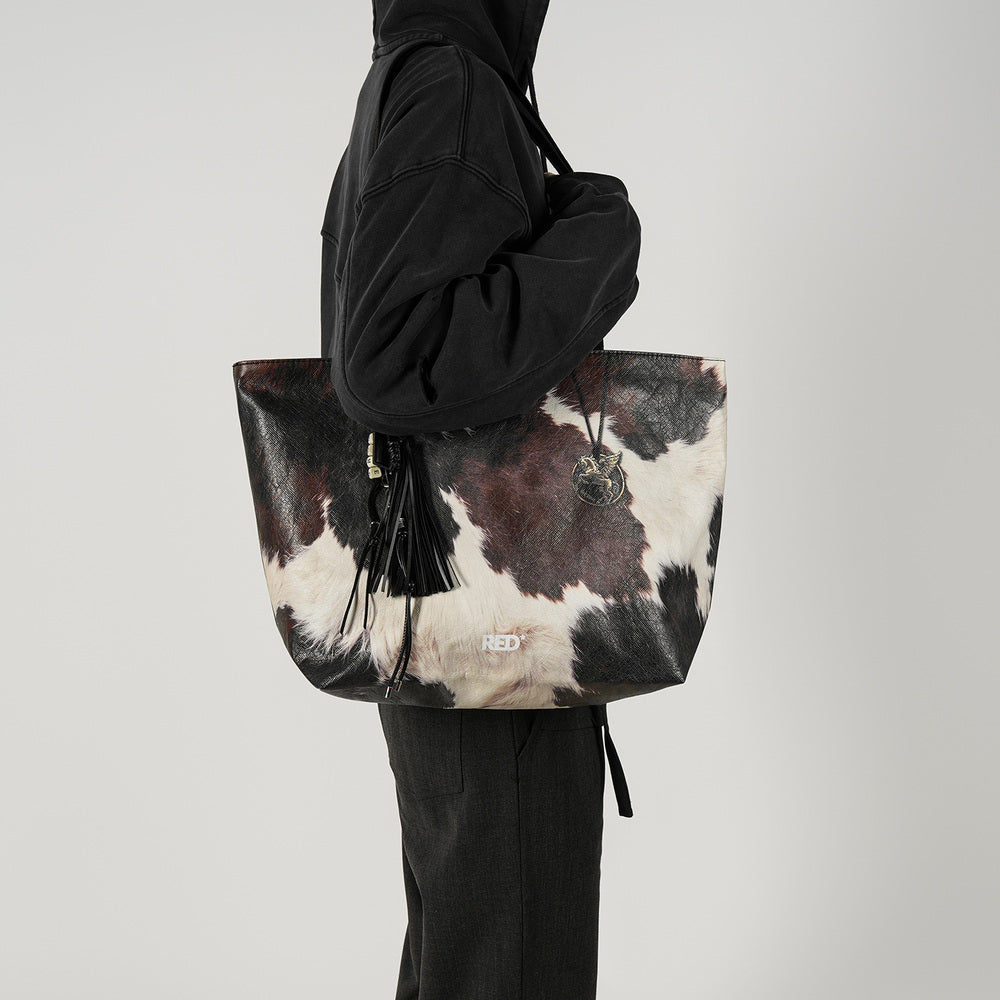 EMBER cow print Tyvek tote bag shoulder styling view