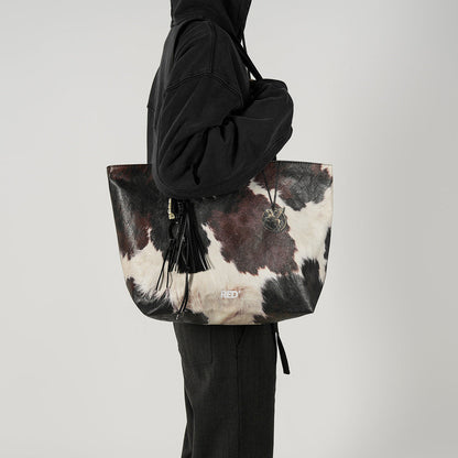 EMBER cow print Tyvek tote bag shoulder styling view