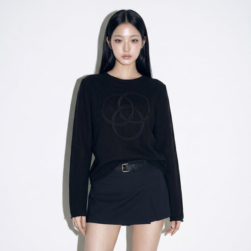 Model wearing WILD LOOP ouroboros knit long sleeve front view