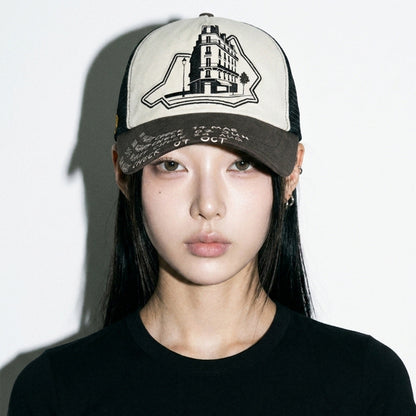 Close front view of model wearing the LOUNGE trucker hat