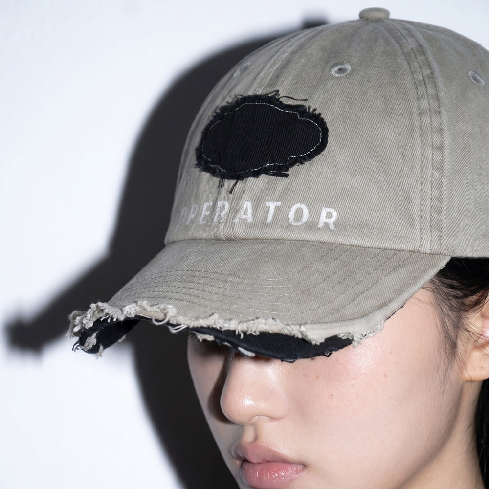 Model wearing REDRINSE OP distressed washed baseball cap close-up
