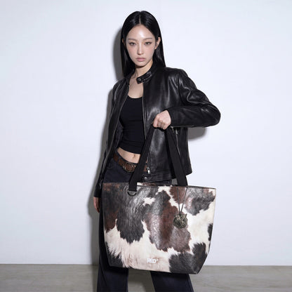 Full outfit view with EMBER cow print Tyvek tote bag