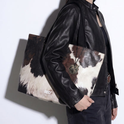 Side styling view of EMBER cow print Tyvek tote bag