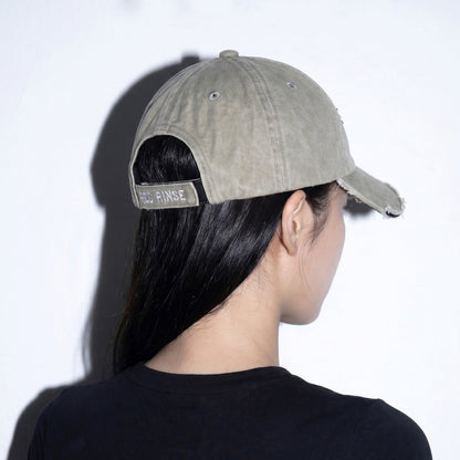 Model wearing REDRINSE OP distressed washed baseball cap rear angled view