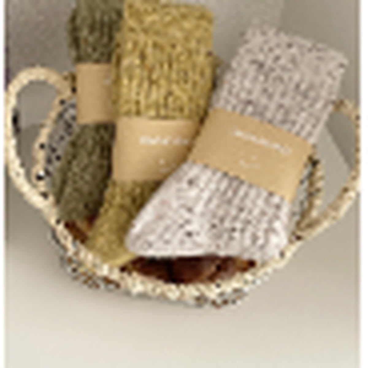 Mustard, moss and ivory wool-blend socks in a basket