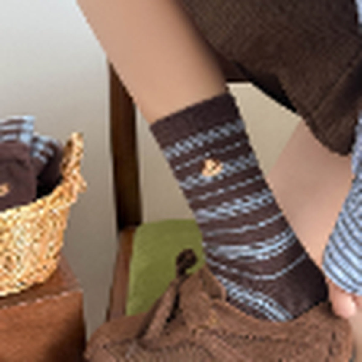 Blue and brown striped crew socks worn slouched