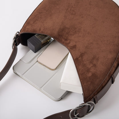 CRESCENT saddle bag capacity shown with tablet and daily essentials