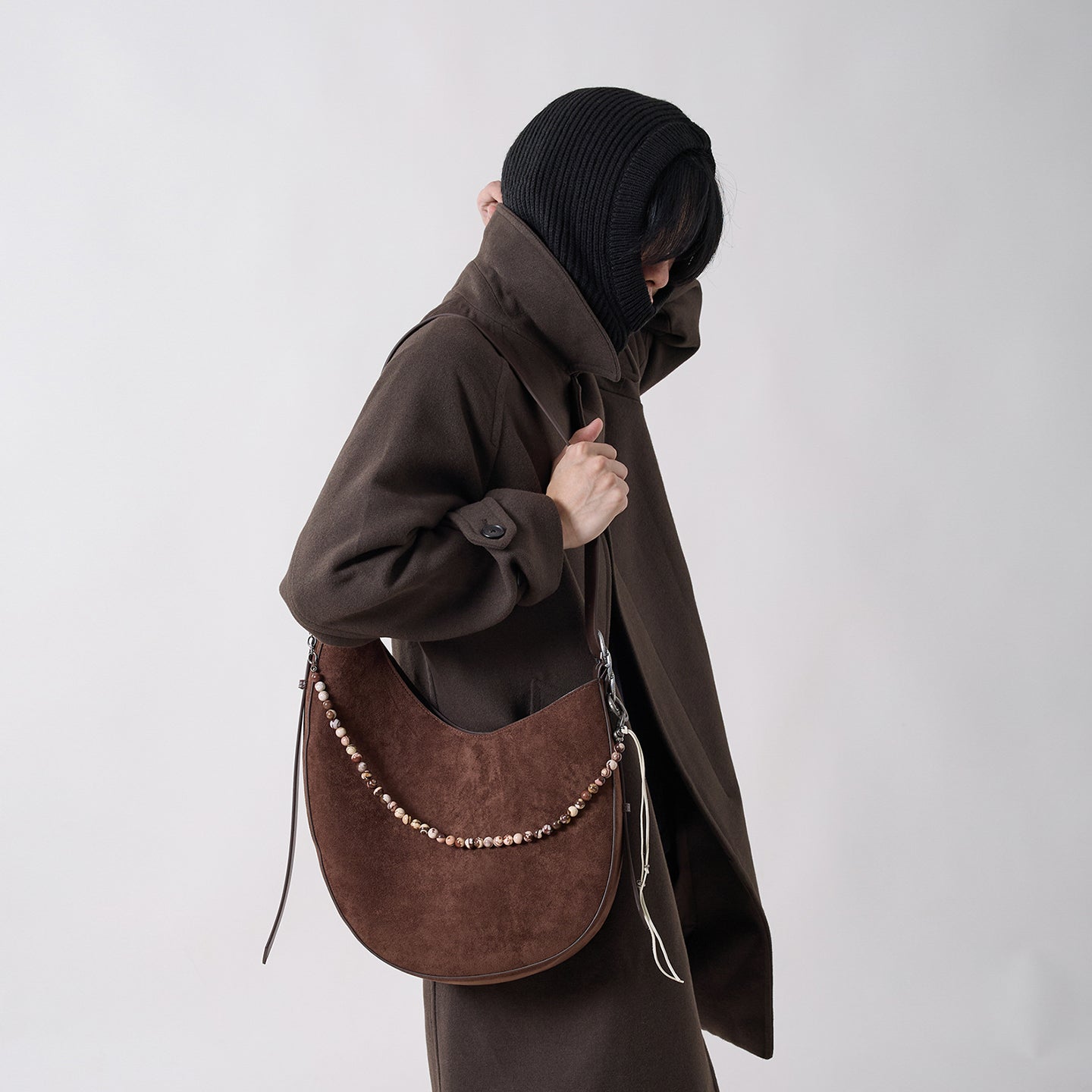 CRESCENT oak brown shoulder bag styled with a dark oversized outfit