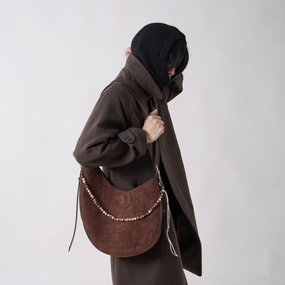 CRESCENT oak brown shoulder bag styled with a dark oversized outfit