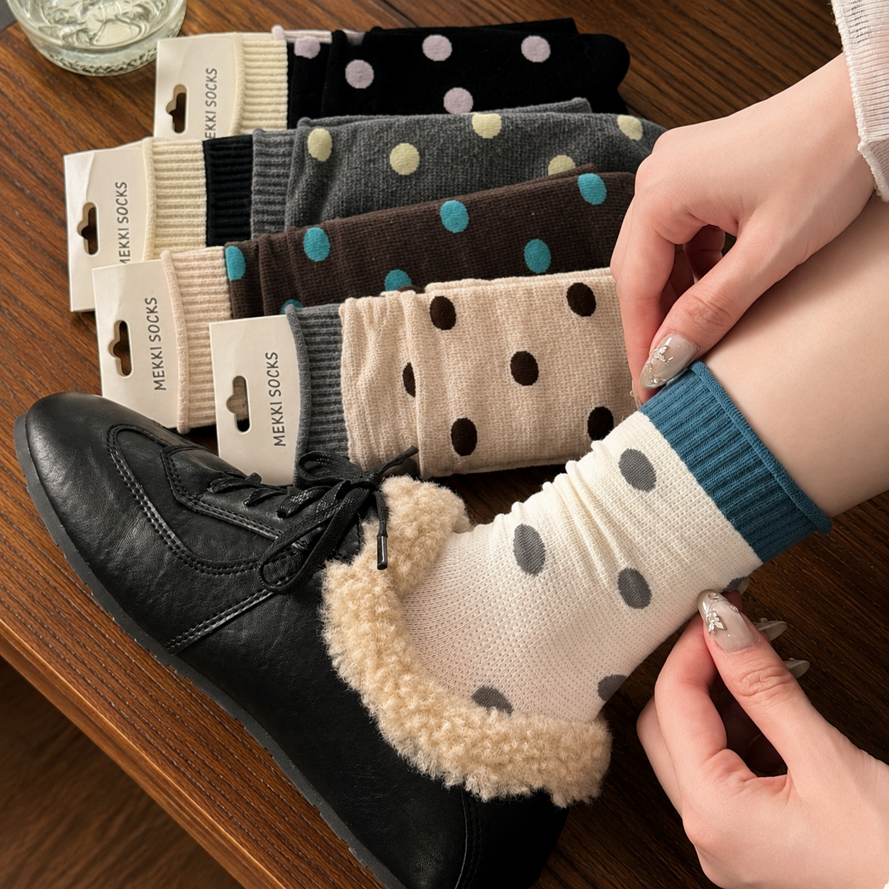 Ivory polka-dot socks styled with black shearling shoes
