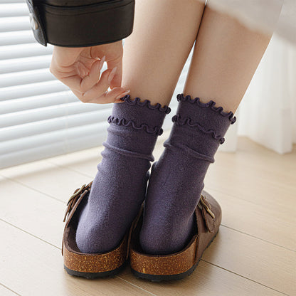 Dusty lavender ruffle-trim crew socks worn with clogs