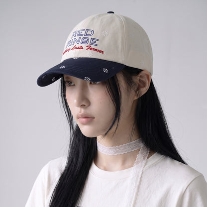 Close-up of REDRINSE SNOWFLAKES floral print and contrast embroidery cap