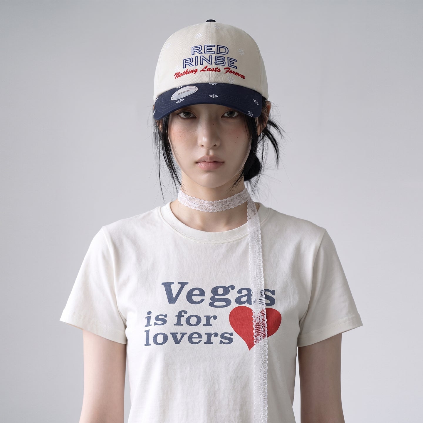 Model wearing REDRINSE SNOWFLAKES cream and navy curved-brim cap