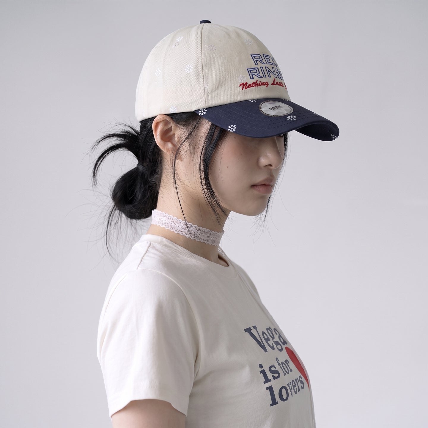 Side view of model wearing REDRINSE SNOWFLAKES floral baseball cap