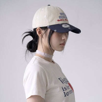 Side view of model wearing REDRINSE SNOWFLAKES floral baseball cap