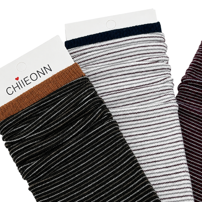 Close-up of black, ivory and burgundy micro-stripe socks on pure white