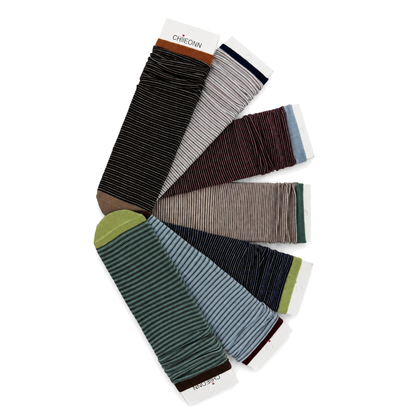 Seven contrast stripe socks arranged in a fan on pure white